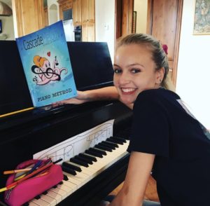 Teenage girl practicing piano using The Cascade Method Piano Theory Book