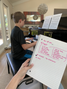 Implementing the piano training tip, young boy practicing his playlist