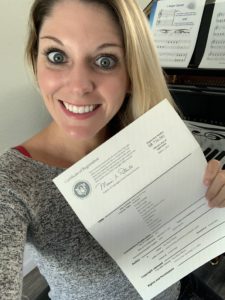 Tara Boykin holding her official paper of copyright 