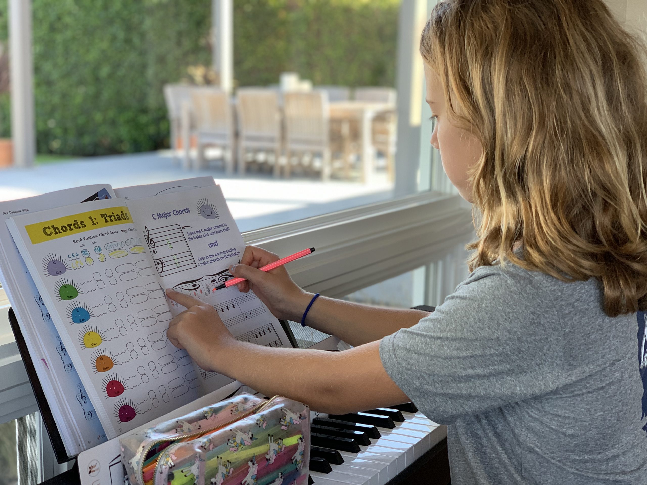 Student drawing in the chords on her mini notematch within the chords 1 book