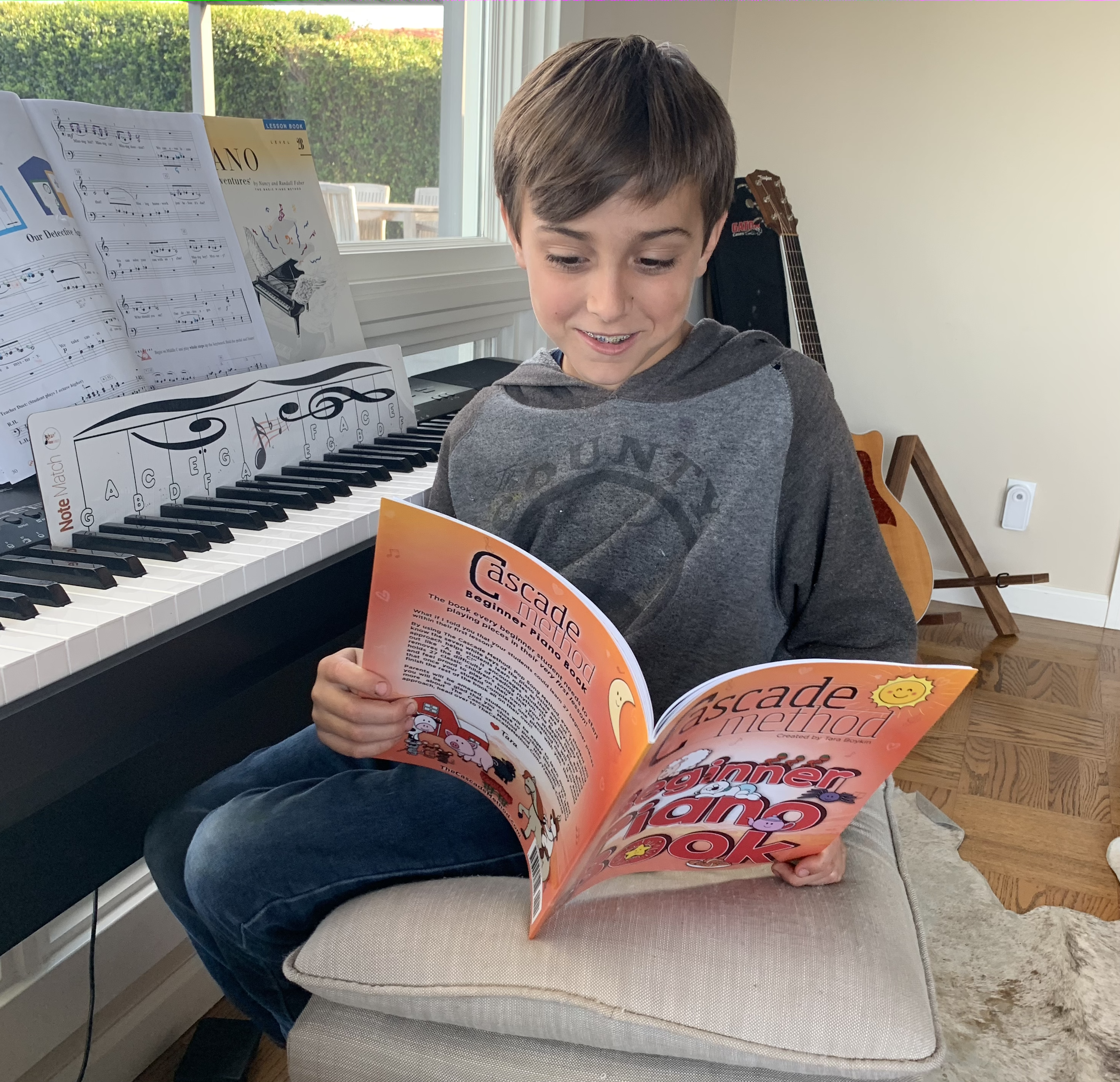 Young boy looking through the Piano Beginner Book