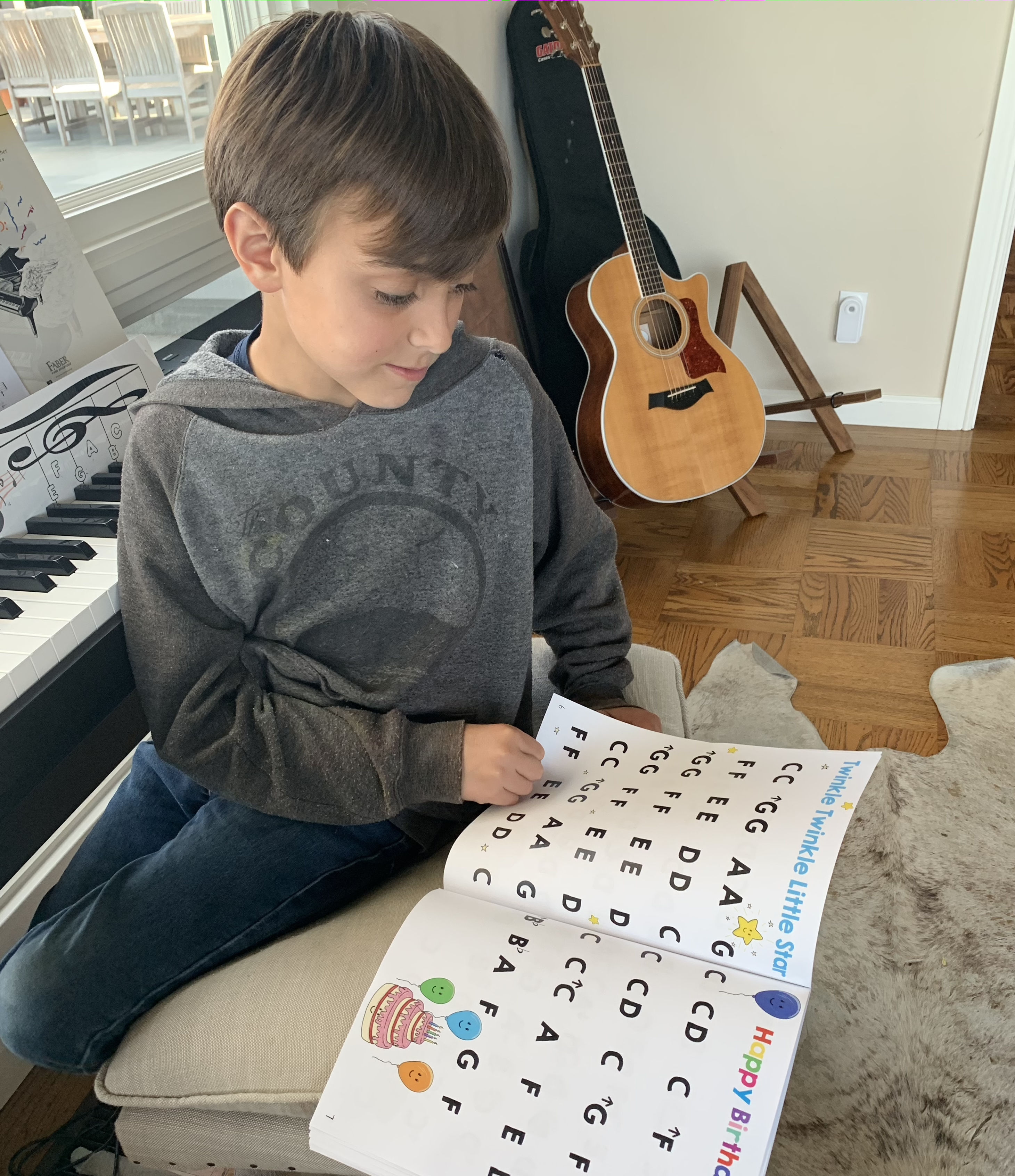 Young boy looking through the Piano Beginner Book