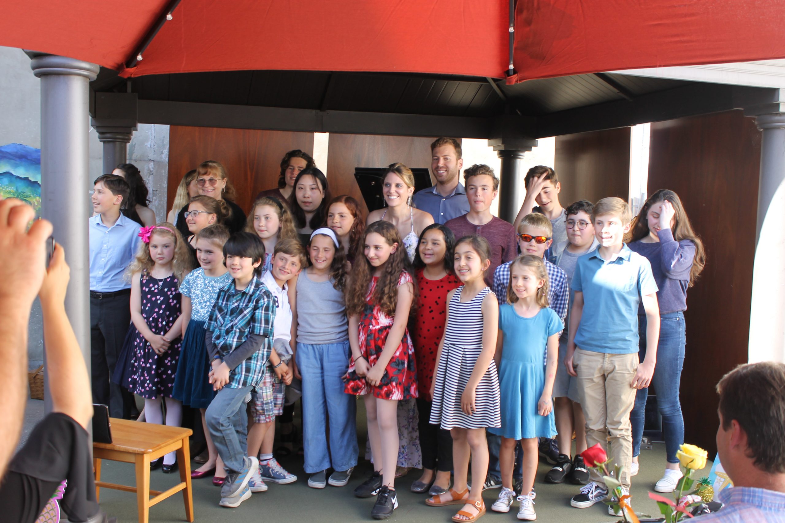 A group photo of Tara with her piano students at an in-person recital